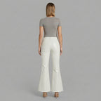 Back view of white genuine leather flares opening from the knee