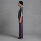 Side view of plum genuine leather high waisted trousers with a wide straight leg