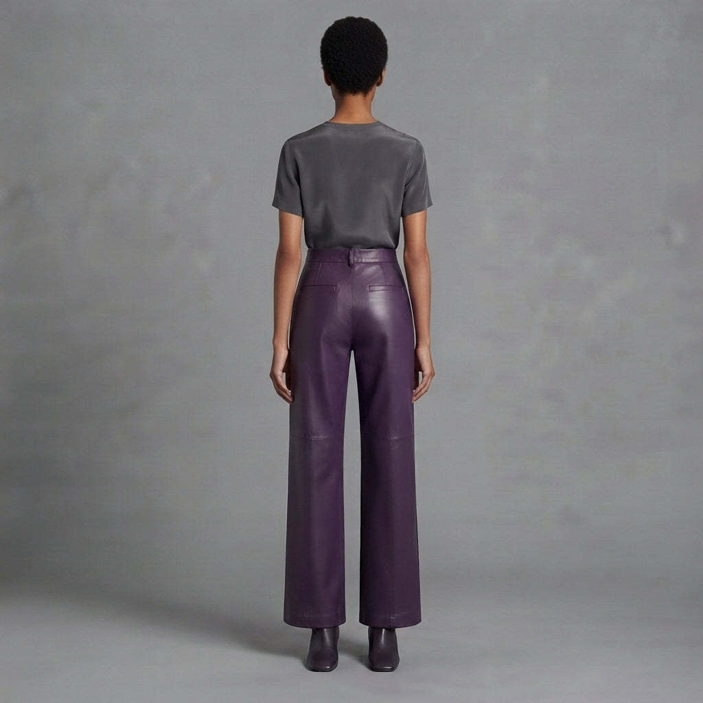 Back view of women's dark purple leather pants falling to a full-length hem