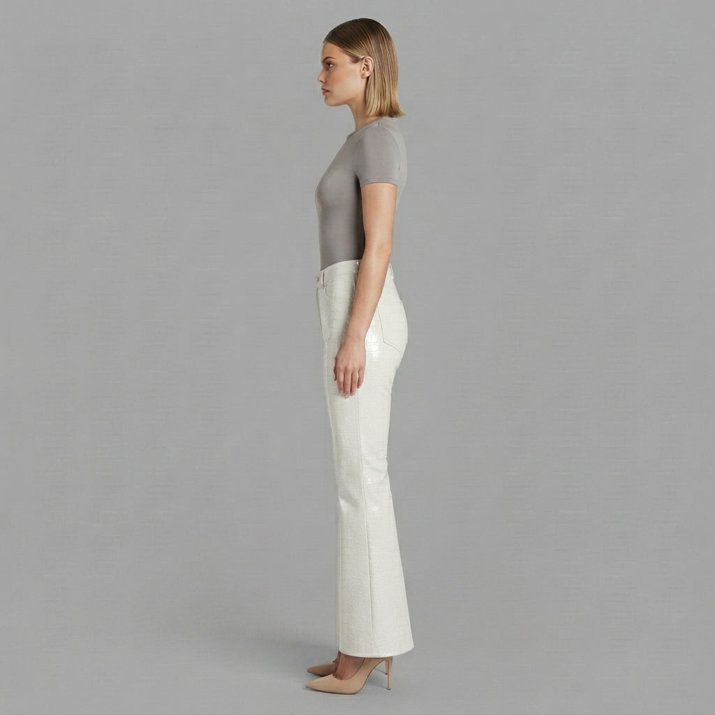 Side profile of women's high waisted white leather flare trousers