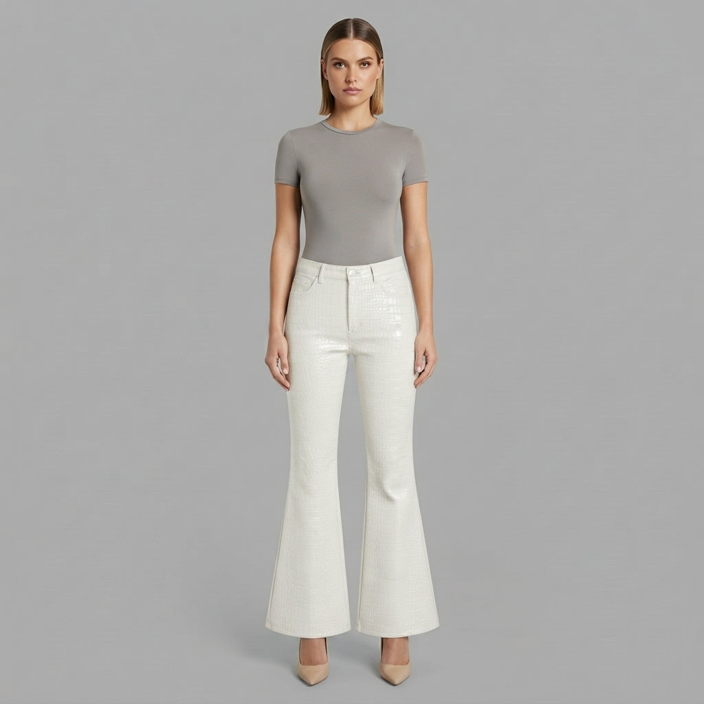 Front view of women's white flared leather pants with grey tee and nude heels