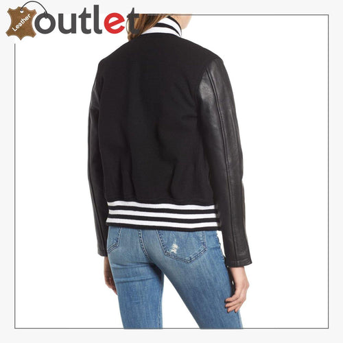 Side view of the womens black varsity jacket showing cropped body